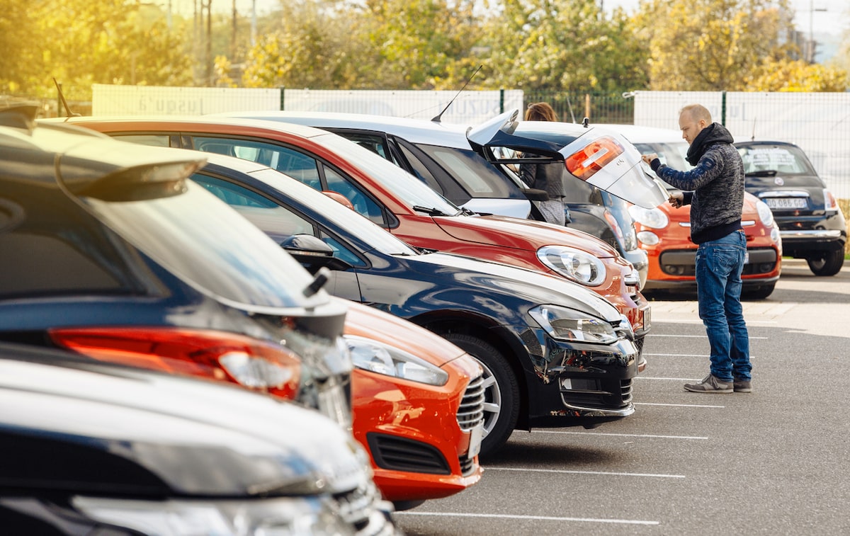 If money is tight right now, why are car sales soaring?